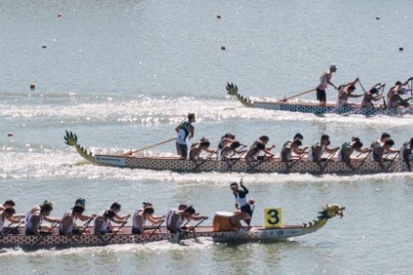 three dragon boats racing on water